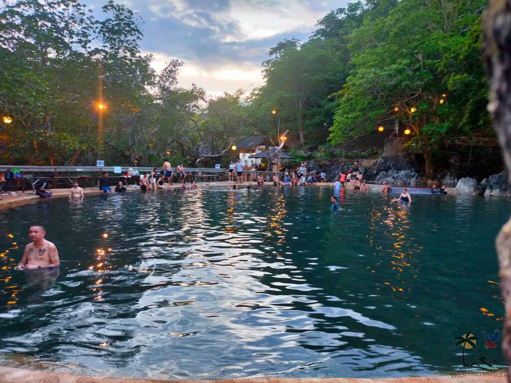 People swimming in Maquinit Hot Spring