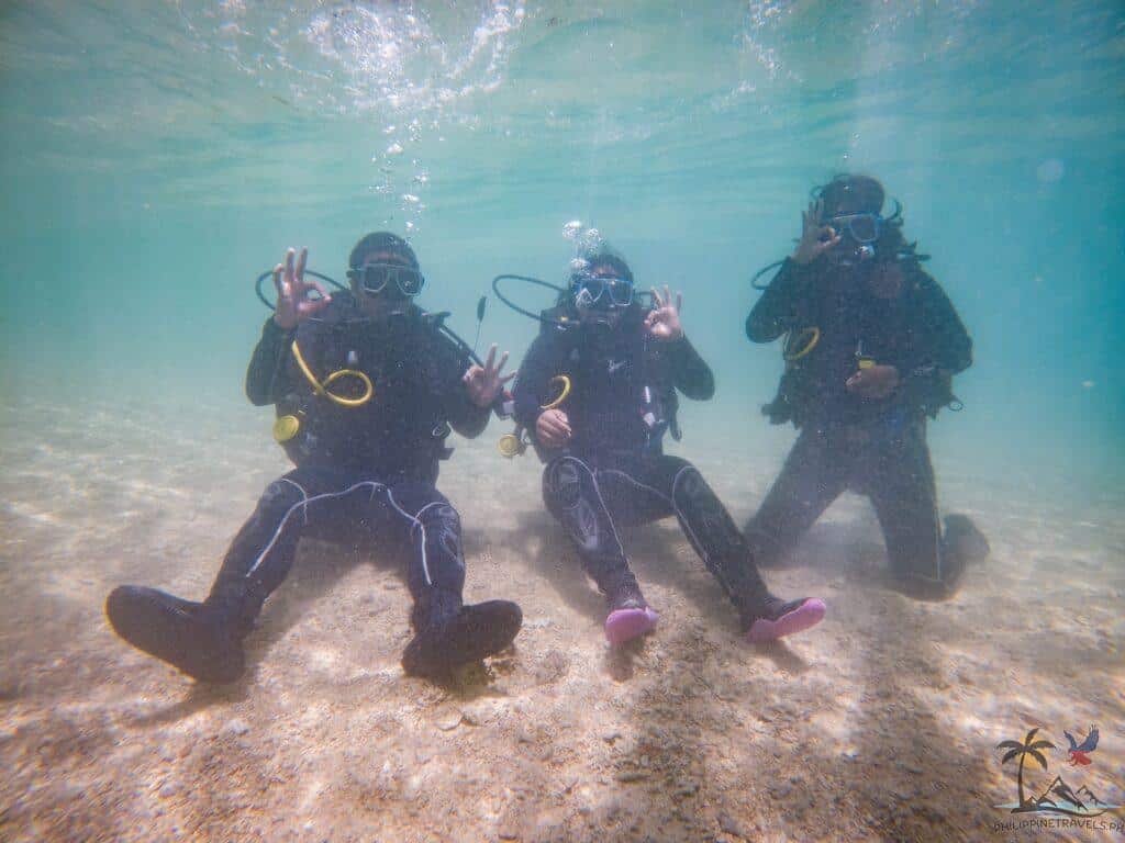 3 people practicing how to scuba dive