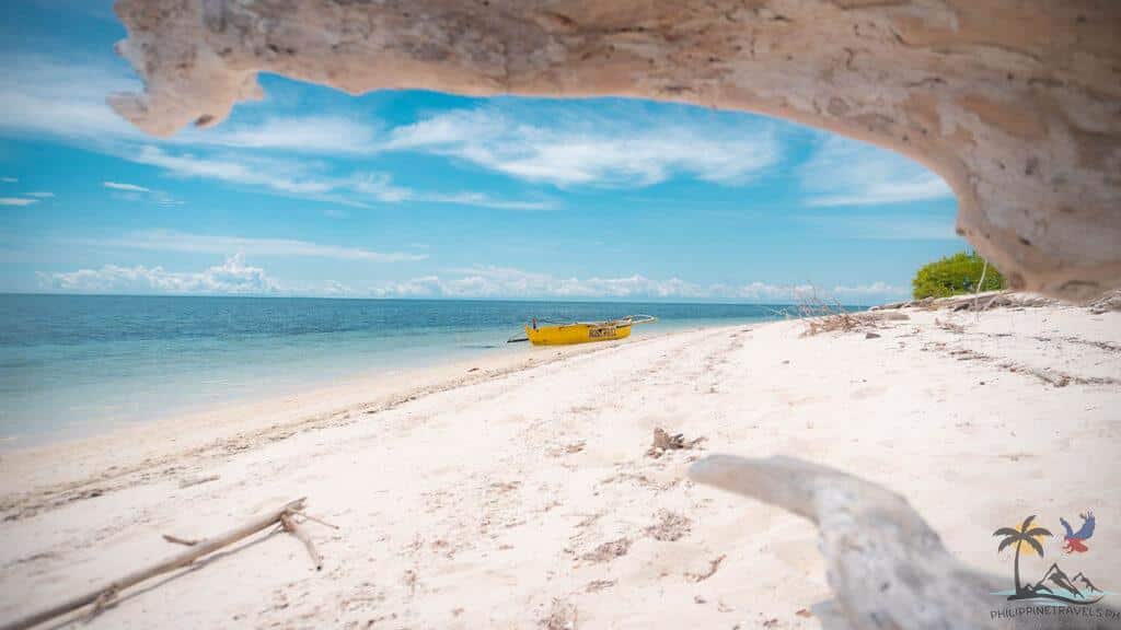 Yellow boat in isolated beach in Mantigue