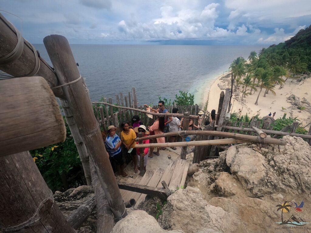 People waiting in line for their turn on Cabugao Gamay's famous viewdeck
