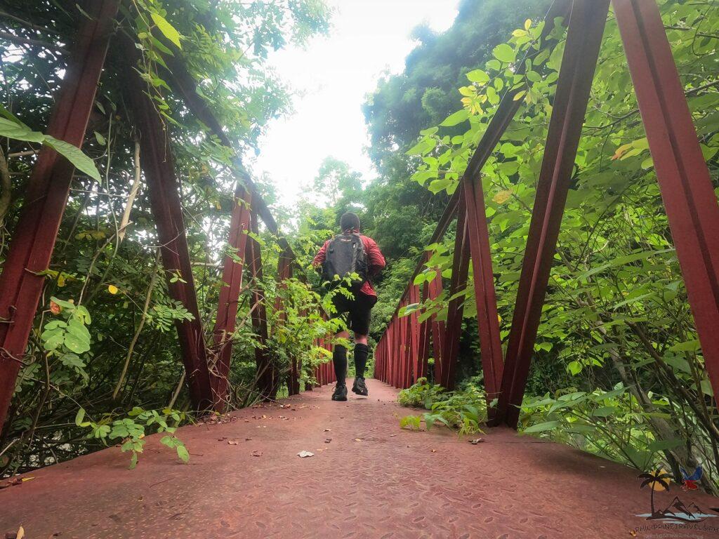 Me crossing the red bridge that leads to nadsadjan falls