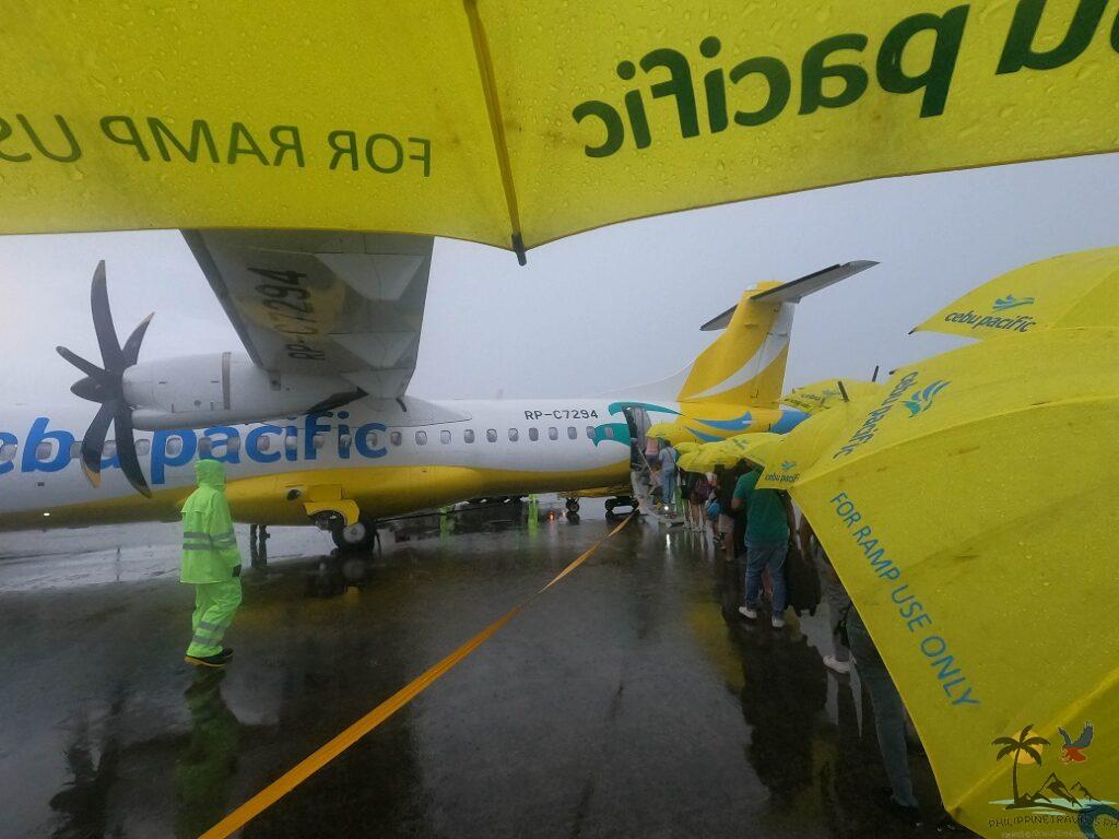 People lining up to go inside airplane