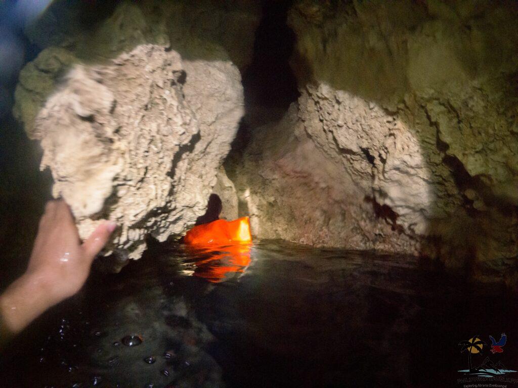 Navigating through Sambulawan underground river's narrow passageways