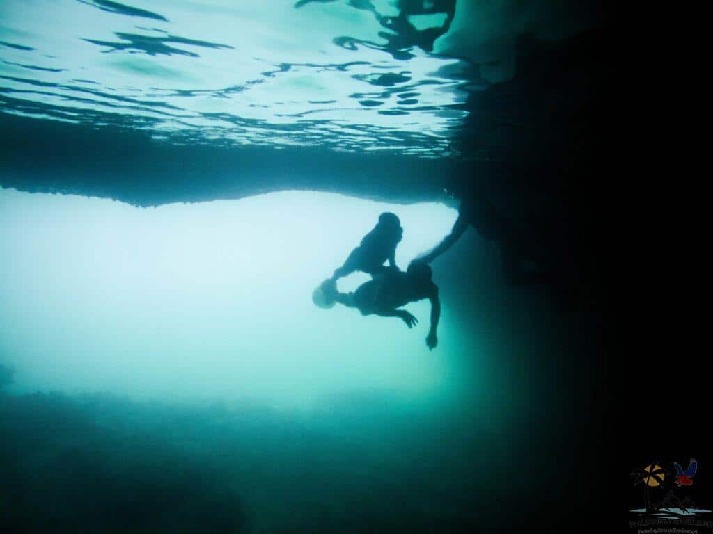 Guide diving inside underwater cave