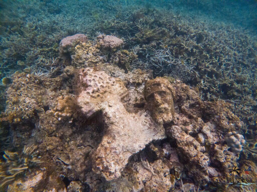 Bust and tombstone in sunken cemetery