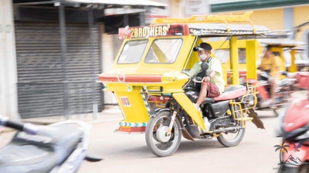 Man driving a tricycle